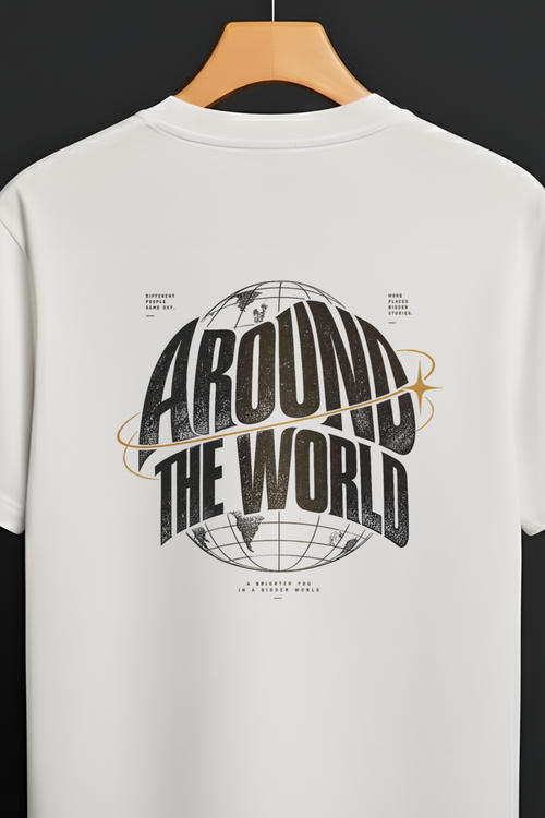 A white short-sleeve t-shirt hanging on a wooden hanger against a dark background. The back of the shirt features a large graphic print with the words 'AROUND THE WORLD' in bold black lettering over a globe design, accented with thin orange lines.