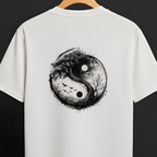 A white short-sleeve T-shirt hanging on a wooden hanger against a dark background, featuring a large black and gray distressed yin-yang graphic printed on the back.