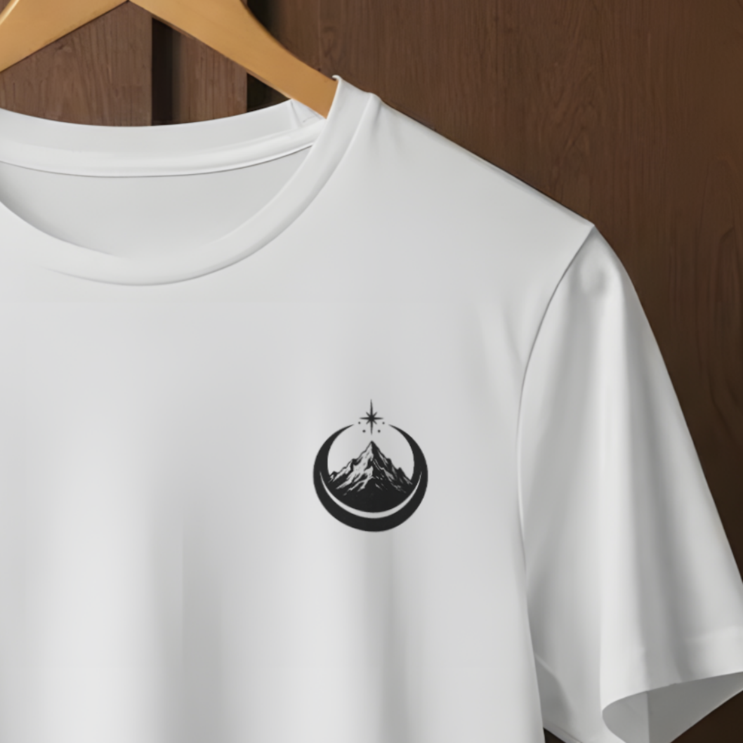 A white short-sleeve crewneck t-shirt hanging on a wooden hanger against a dark brown wooden paneled wall. The shirt features a small black circular logo printed on the left chest.
