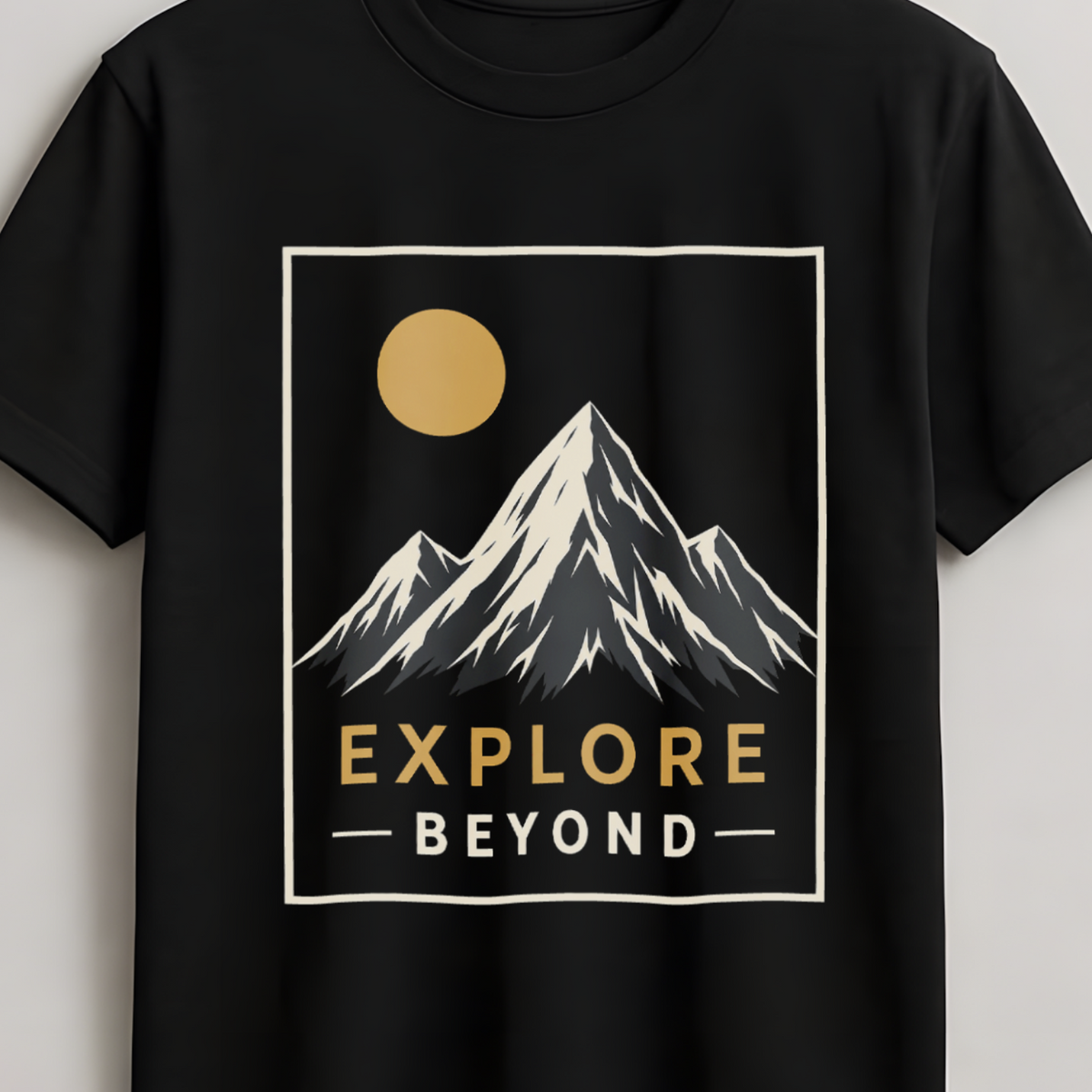 A black short-sleeve crewneck t-shirt hanging on a wooden hanger against a light gray wall. The shirt features a graphic print of a mountain peak with a yellow sun and the text 'EXPLORE BEYOND' in yellow and white.