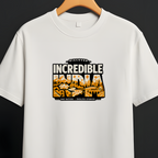 A white short-sleeve crewneck t-shirt hanging on a wooden hanger from a black clothing rack against a dark gray background. The shirt features a graphic print on the chest with the words 'INCREDIBLE INDIA' in bold black letters over a stylized orange and yellow map design.