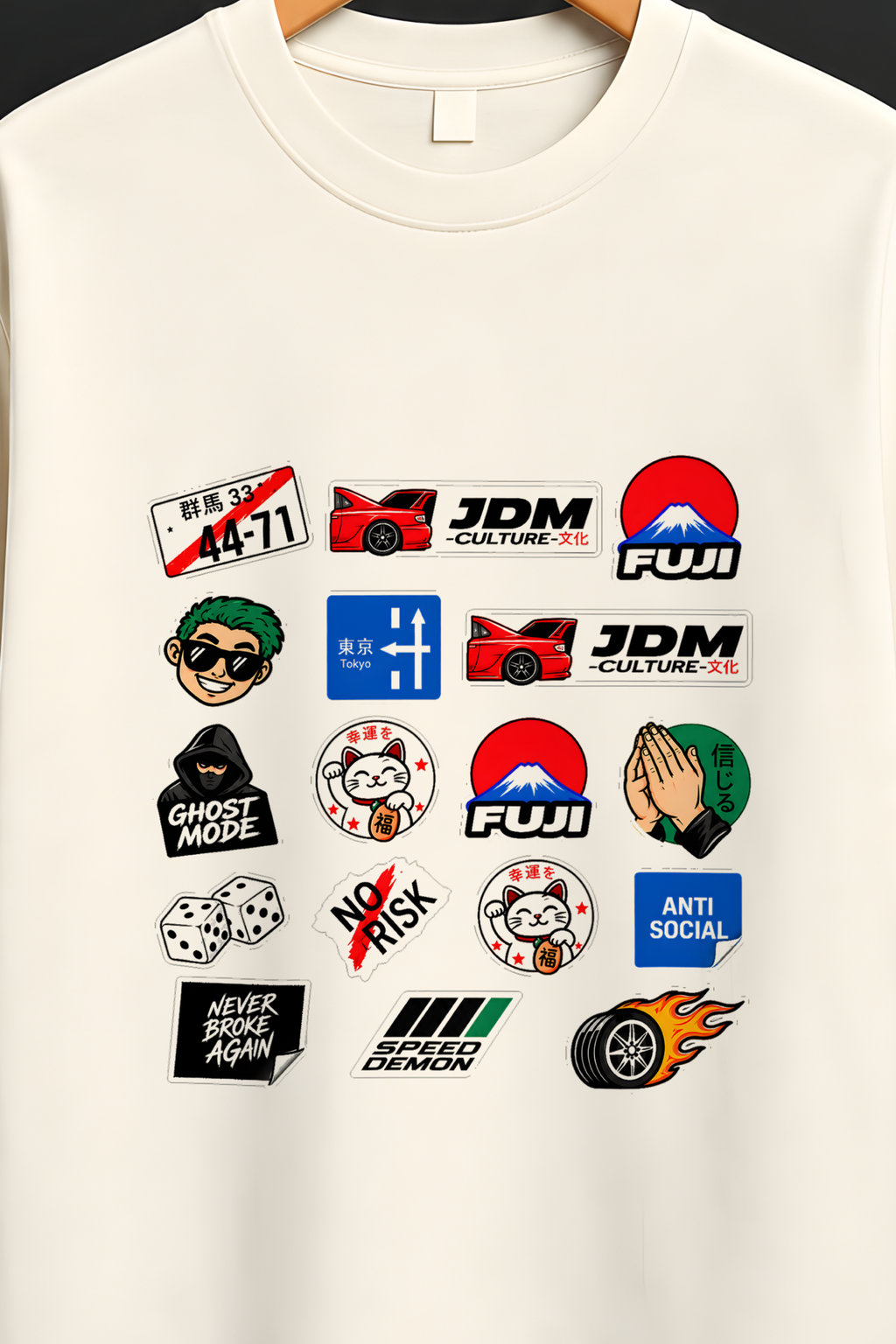 An off-white short-sleeve t-shirt hanging on a wooden hanger against a dark background. The shirt features a grid of colorful JDM (Japanese Domestic Market) and rally-style graphic patches on the front.