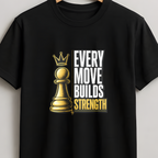 A black short-sleeve crewneck t-shirt hanging on a wooden hanger against a light gray wall. The shirt features a graphic print of a gold chess pawn with a crown next to the text 'EVERY MOVE BUILDS STRENGTH' in white and gold.