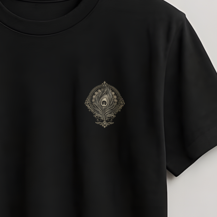A black short-sleeve crewneck t-shirt hanging on a wooden hanger against a light gray wall. The shirt features a small, dark embroidered crest logo on the left chest.