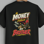 A black short-sleeve t-shirt hanging on a wooden hanger against a solid gray background, showing the back of the shirt with a colorful graphic print that reads 'MONEY follows MY BROTHER' with cartoon money and a figure.
