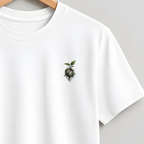 A white short-sleeve crewneck t-shirt hanging on a wooden hanger against a solid light gray background. The shirt features a small embroidered rose motif on the left chest.