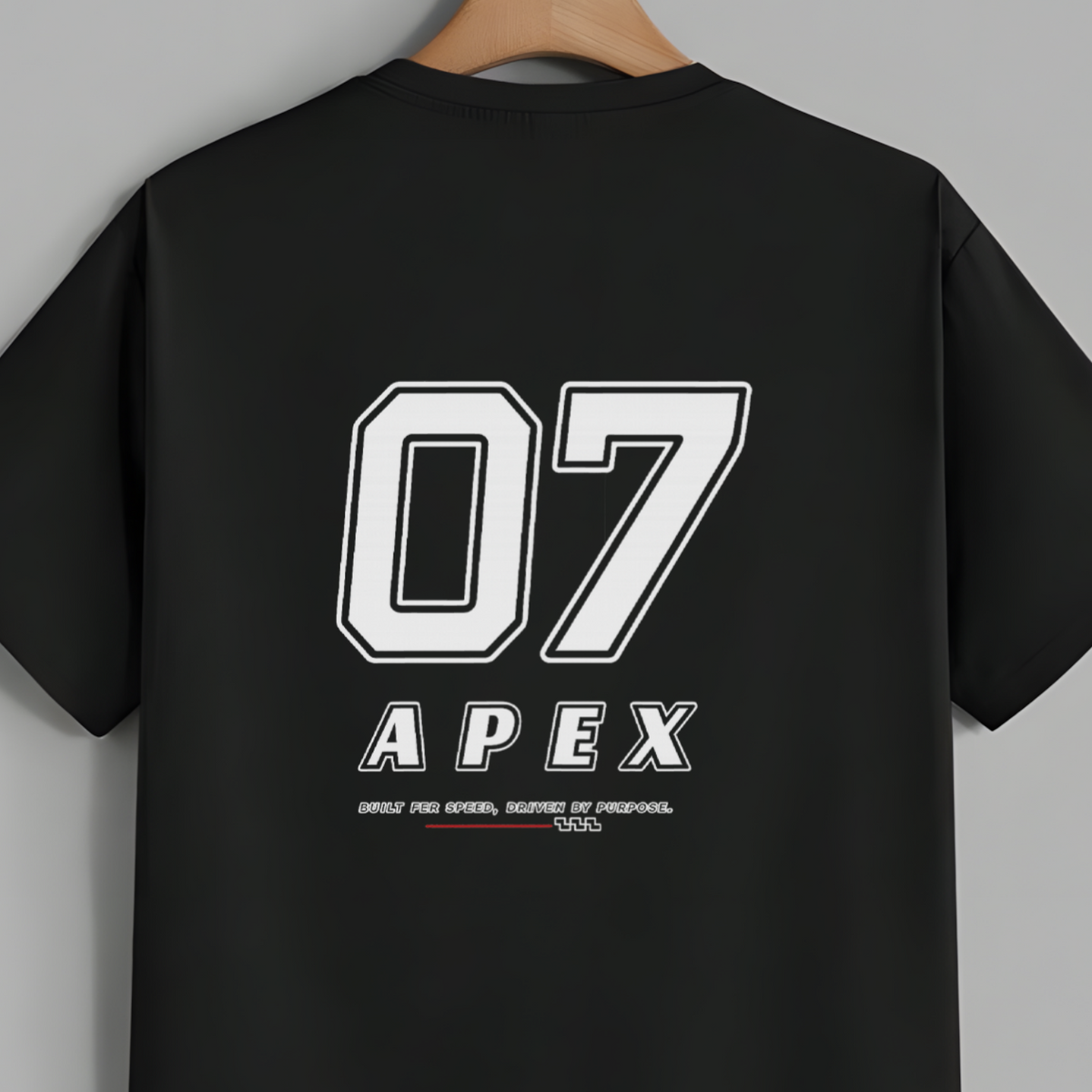 A black short-sleeve t-shirt hanging on a wooden hanger against a solid gray background. The back of the shirt features a large white graphic print with the number '07' and the brand name 'APEX'.