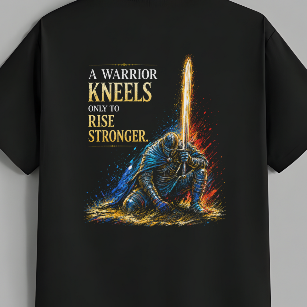 A black short-sleeve t-shirt hanging on a wooden hanger against a solid gray background. The back of the shirt features a large graphic print of a knight in blue armor kneeling with a glowing sword, accompanied by the text 'A WARRIOR KNEELS ONLY TO RISE STRONGER.