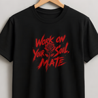 A black short-sleeve crewneck t-shirt hanging on a wooden hanger against a light gray wall. The shirt features a distressed red graphic on the chest with the text 'WORK ON YOUR SOUL.